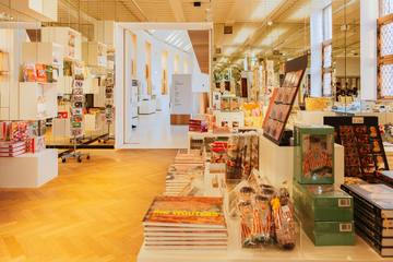 A view of an open, light-filled museumshop displaying a variety of items.